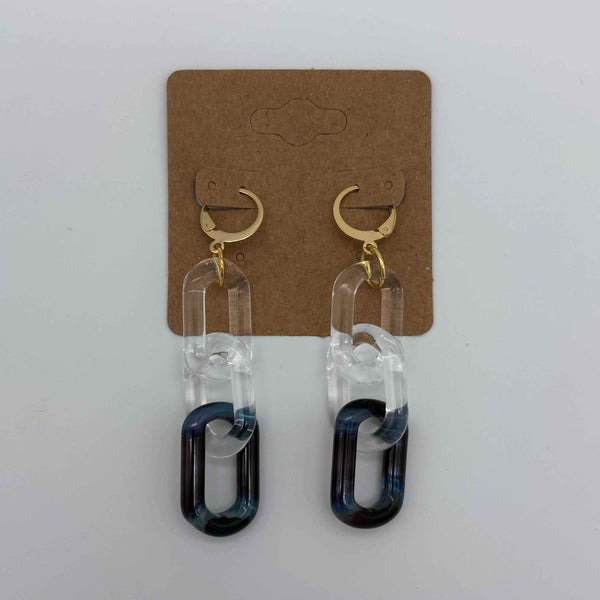 These are 3 link Amber Purple Glass Chain Earrings by Biting Glass available at Ritual Colorado. Featuring vibrant color accents these handmade jewelry pieces are the perfect accent accessory.