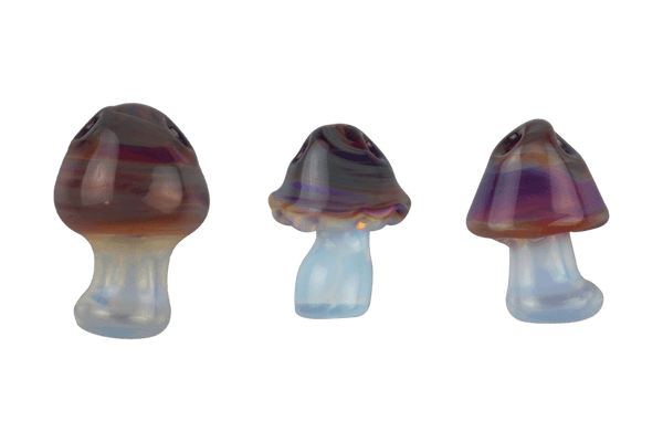 These are Trippy Shroom Glass Pendants by Technicolor Tony available at Ritual Colorado. Featuring Amber Purple and Ghost glass with two holes so you can thread them onto your favorite necklace.