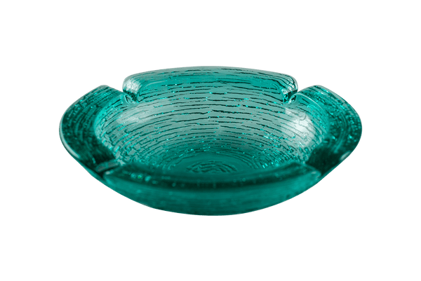 This is an Anchor Hocking Soreno Glass Ashtray in aqua from Heady Vintage available at Ritual Colorado. It features a deep well in the center with four indents around the edge for easy storage of your dry herb vaporization and dabbing tools.