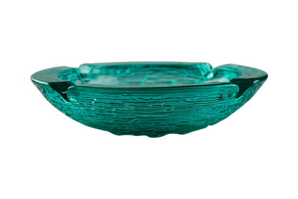 This is an Anchor Hocking Soreno Glass Ashtray in aqua from Heady Vintage available at Ritual Colorado. It features a deep well in the center with four indents around the edge for easy storage of your dry herb vaporization and dabbing tools.