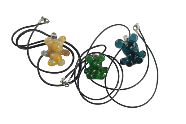 These are Glass Gummy Bear Pendants by Biting Glass available at Ritual Colorado. Fun handmade borosilicate glass jewelry piece made in Denver, Colorado.
