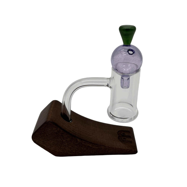 This is the Purple Heady Hollow Bubble Cap by Biting Glass available at Ritual Colorado. Featuring a solid handle accented by a hollow bubble for precise airflow in your banger.