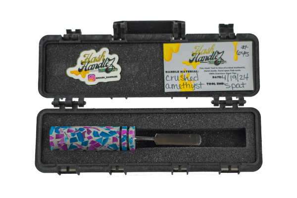 This is the Crushed Amethyst dab tool from Hash Handlez available at Ritual Colorado. A beautiful handmade dab tool featuring a colorful resin handle and protective hard case.