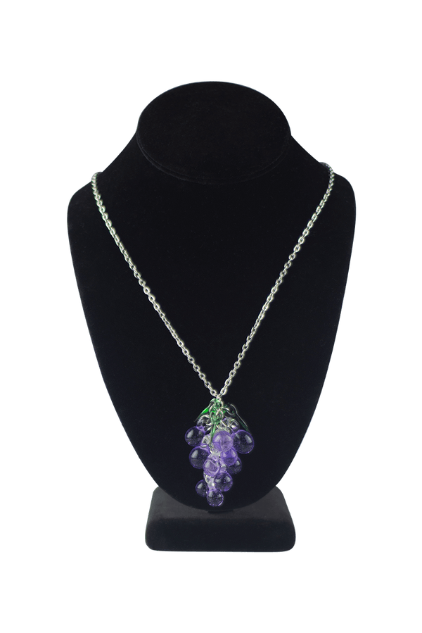 This is the Dionysus Grape Necklace by Hobbitkraft Glass available at Ritual Colorado. Featuring a gorgeous cluster of purple glass grapes accented by three green leaves for a one-of-a-kind jewelry piece.
