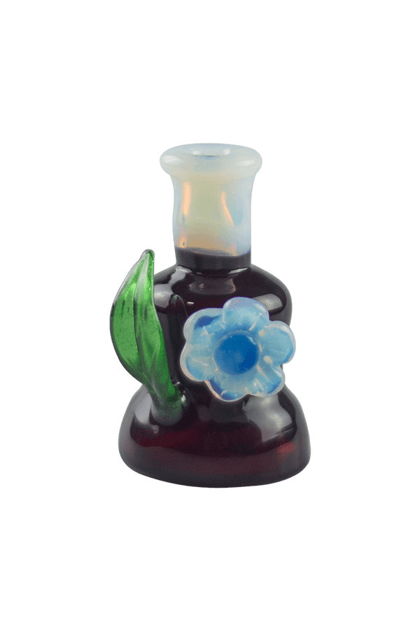 This is the Dark Phoenix Flower Top by Technicolor Tony available at Ritual Colorado. Featuring a ghost mouthpiece and flower and a green stardust leaf this is a fun upgrade for your Puffco Peak.