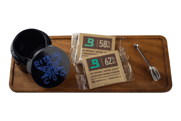 This is the Dry Herb Starter Bundle available at Ritual Colorado. Featuring a wooden rolling tray, titanium herb scoop, glass stash jar and two Boveda packs this has everything you need for the perfect dry herb sesh.