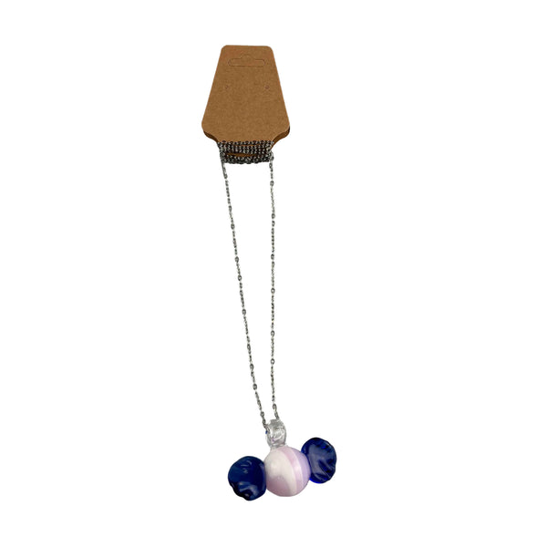 This is the Glass Candy Necklace by Biting Glass available at Ritual Colorado. Featuring a pink & white swirling candy with twisting blue wrappers on each side. This fun necklace comes on an 18" stainless steel chain.