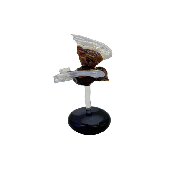This is the Glass Soaring Hawk Sculpture by Biting Glass available at Ritual Colorado. A stylish borosilicate glass sculpture featuring a hawk soaring with wings out attached to a dark blue base with subtle "clouds".