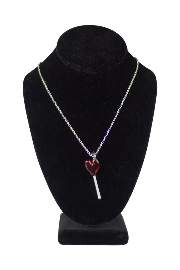This is the Glass Heart Lollipop Necklace by Hobbitkraft Glass available at Ritual Colorado. A sleek all-glass pendant made in Denver, CO on a stainless steel chain.