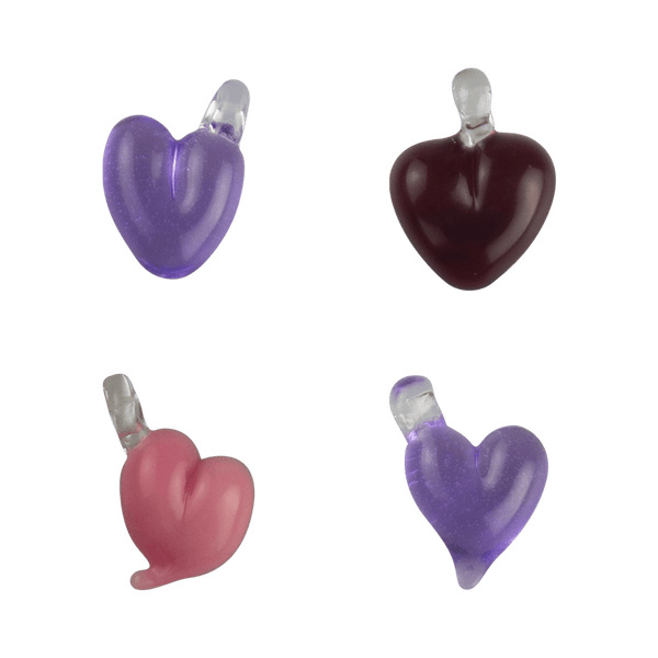 These are Solid Heart Pendants by Technicolor Tony available at Ritual Colorado. Featuring vibrant glass hearts with a clear bail so you can thread onto your favorite jewelry.