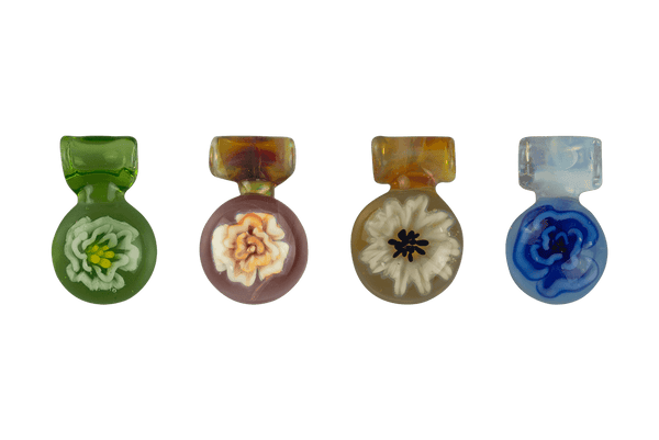 These are Flower Medallion Pendants by Biting Glass available at Ritual Colorado. A beautiful handmade borosilicate jewelry piece with hidden sparkly details.