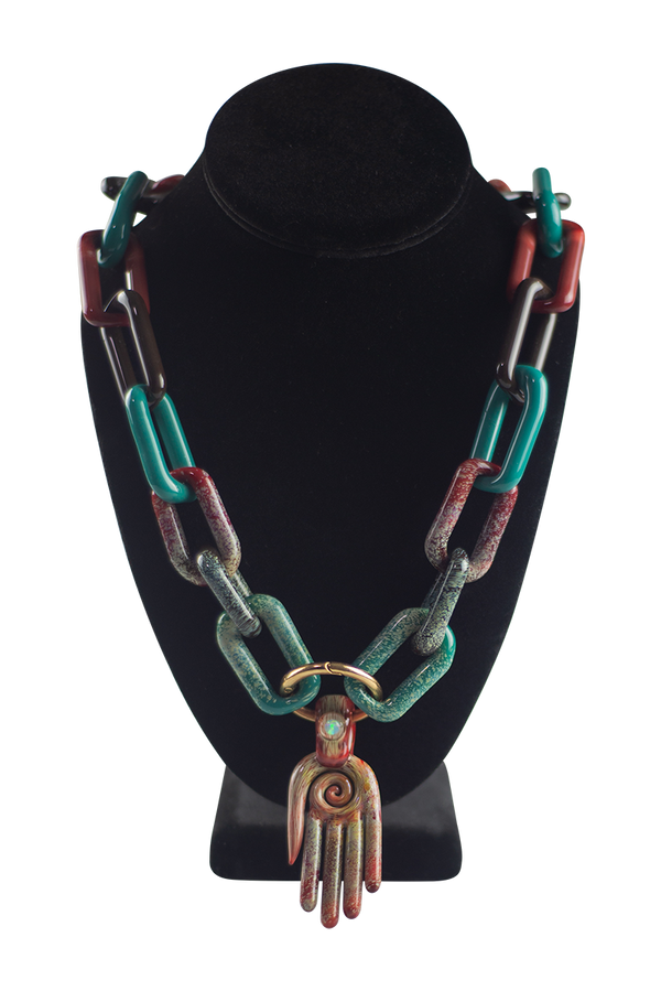 This is a collab glass chain necklace by Technicolor Tony & Maze Glass available at Ritual Colorado. Made here in Denver and featuring accents from both artists this is a one-of-a-kind headie glass masterpiece.
