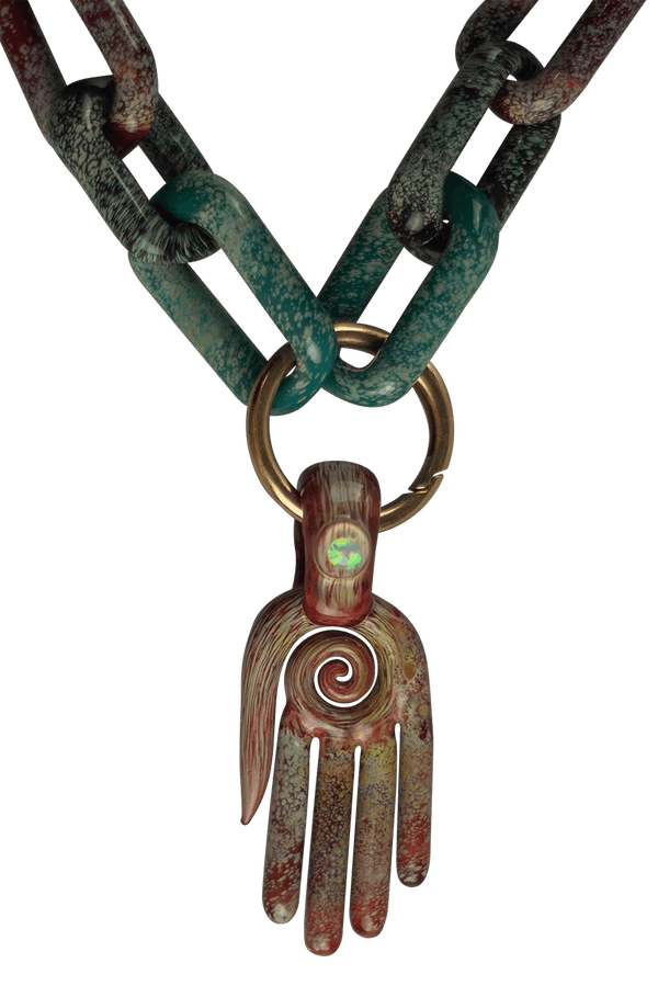 This is a collab glass chain necklace by Technicolor Tony & Maze Glass available at Ritual Colorado. Made here in Denver and featuring accents from both artists this is a one-of-a-kind headie glass masterpiece.