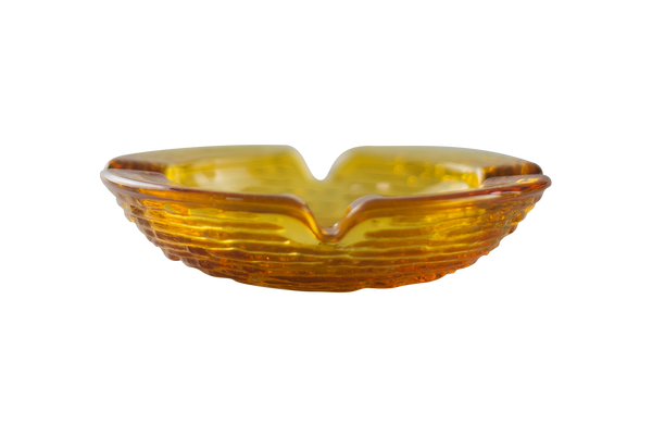 This is an Anchor Hocking Soreno Glass Ashtray in amber from Heady Vintage available at Ritual Colorado. It features a shallow well in the center with four indents around the edge for easy storage of your dry herb vaporization and dabbing tools.