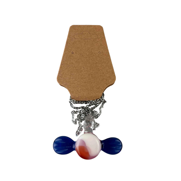 This is the Glass Candy Necklace by Biting Glass available at Ritual Colorado. Featuring a pink & white swirling candy with twisting blue wrappers on each side. This fun necklace comes on an 18" stainless steel chain.