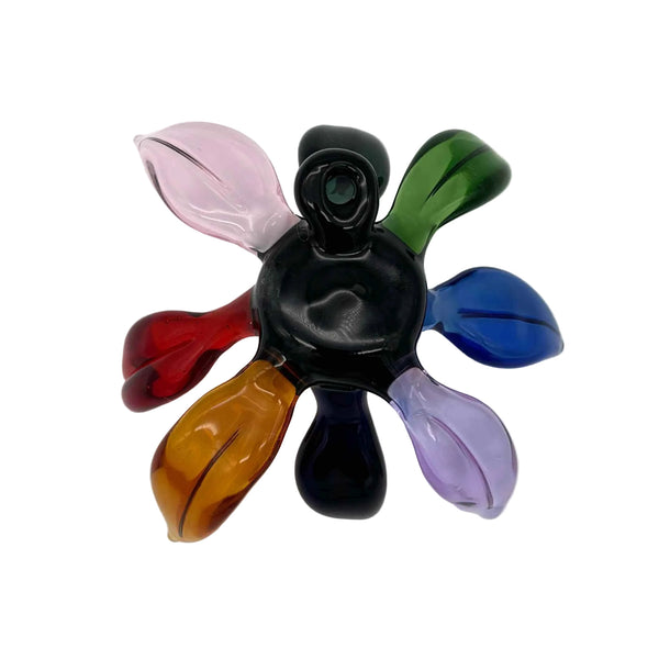 This is the Rainbow (Black Center) Glass Flower Wall Hanging by Biting Glass available at Ritual Colorado. Featuring vibrant glass colors this handcrafted decor piece is the perfect way to spruce up a wall and comes alive in front of a window or other light source.
