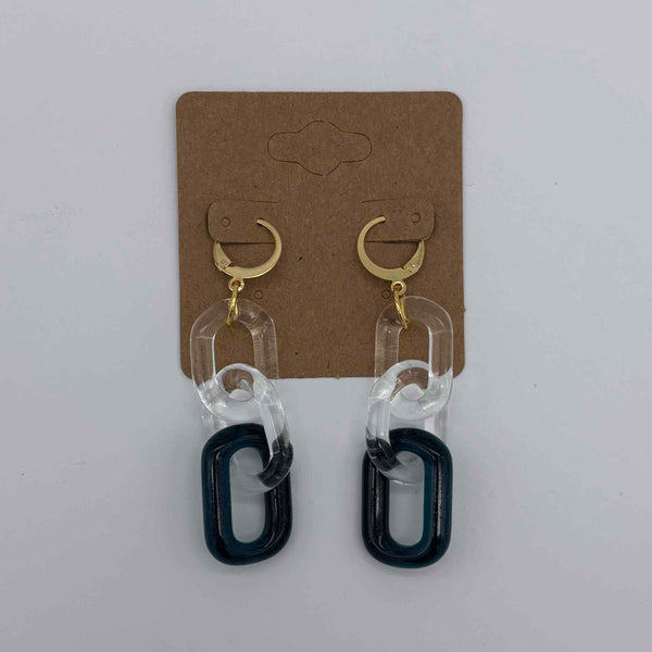These are 3 link Sparkle Blue Glass Chain Earrings by Biting Glass available at Ritual Colorado. Featuring vibrant color accents these handmade jewelry pieces are the perfect accent accessory.