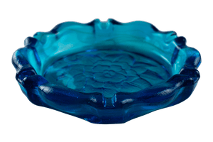 This is the Tiara Indiana Glass Horizon Blue Lotus Ashtray from Heady Vintage available at Ritual Colorado. The large blue ashtray features an imprinted flower in the base and many channels for keeping your joints, dry herb devices and accessories organized.