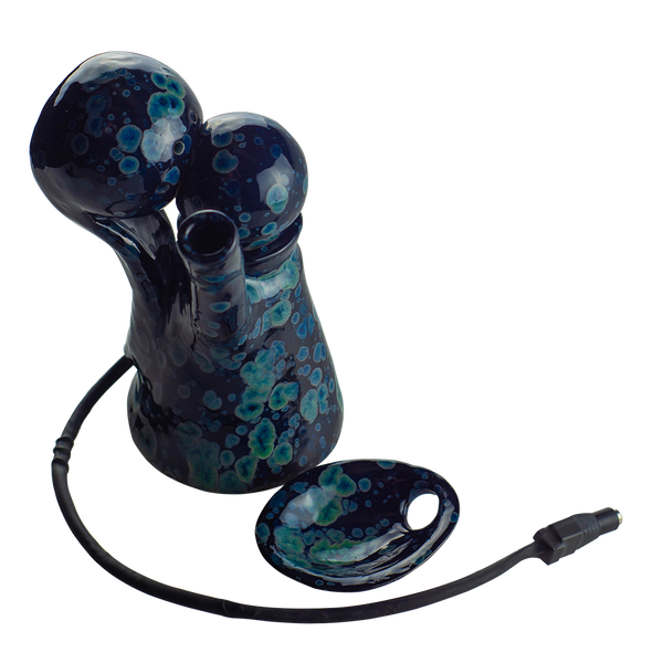 This is the VapBong Obsidian Old School Mini OAB from Jaxel's Art available at Ritual Colorado. It is an all-in-one ceramic water piece and dry herb vaporizer capable of powerful vapor and delicious flavors. Simply set the power level on the included voltage meter and after preheating load your material into the ceramic bowl, place under the heater and begin to inhale.