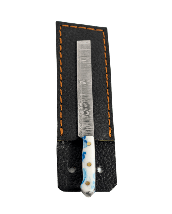 This is the sushi knife dab tool from Dabmascus available at Ritual. It features a three-pin handle and sushi-knife style blade from high-quality Damascus Steel.