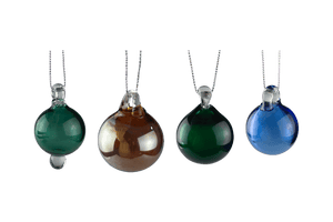 These are Holiday Globe Ornaments by Biting Glass available at Ritual Colorado. Classic sphere ornaments in vibrant colors and featuring a built-in glass bail for longevity.