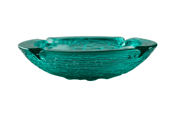 This is an Anchor Hocking Soreno Glass Ashtray in aqua from Heady Vintage available at Ritual Colorado. It features a deep well in the center with four indents around the edge for easy storage of your dry herb vaporization and dabbing tools. 