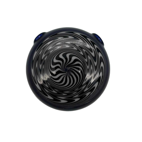 This is the hypnotizing Black & White Swirl Disc Pendant by Biting Glass available at Ritual Colorado. Featuring an intricate black & white pattern accented by deep blue glass on the back this is a bold and stylish jewelry piece.