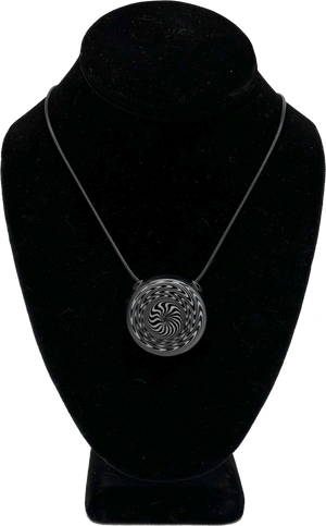 This is the hypnotizing Black & White Swirl Disc Pendant by Biting Glass available at Ritual Colorado. Featuring an intricate black & white pattern accented by deep blue glass on the back this is a bold and stylish jewelry piece.