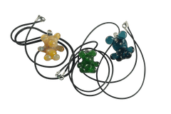 These are Glass Gummy Bear Pendants by Biting Glass available at Ritual Colorado. Fun handmade borosilicate glass jewelry piece made in Denver, Colorado.
