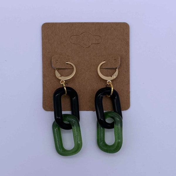 These are 2 link Black / Sparkle Green Glass Chain Earrings by Biting Glass available at Ritual Colorado. Featuring vibrant color accents these handmade jewelry pieces are the perfect accent accessory.
