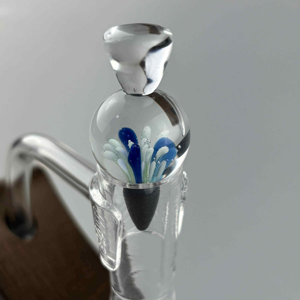 These are Solid Spike Carb Caps by Biting Glass available at Ritual Colorado. Featuring a 21mm marble in the center with a flared handle on top and airflow disrupting spike on bottom.