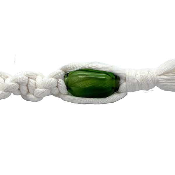 This is the Emerald Handmade Glass Macrame Bead (5mm ID) by Biting Glass available at Ritual Colorado. Hand crafted in Denver, Colorado these sleek beads are the perfect accent for your craft project.
