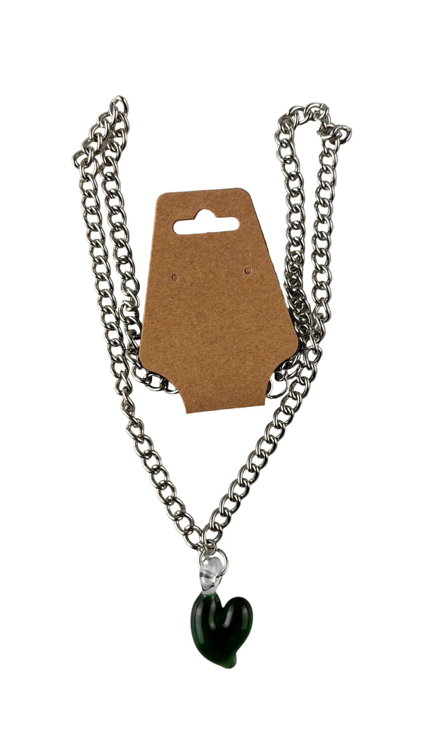 This is the Solid Glass Heart Necklace by Hobbitkraft Glass available at Ritual Colorado. Featuring a green glass heart on a clear bail attached to a metal chain for a stylish handmade piece of jewelry.