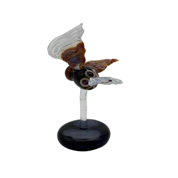 This is the Glass Soaring Hawk Sculpture by Biting Glass available at Ritual Colorado. A stylish borosilicate glass sculpture featuring a hawk soaring with wings out attached to a dark blue base with subtle "clouds".