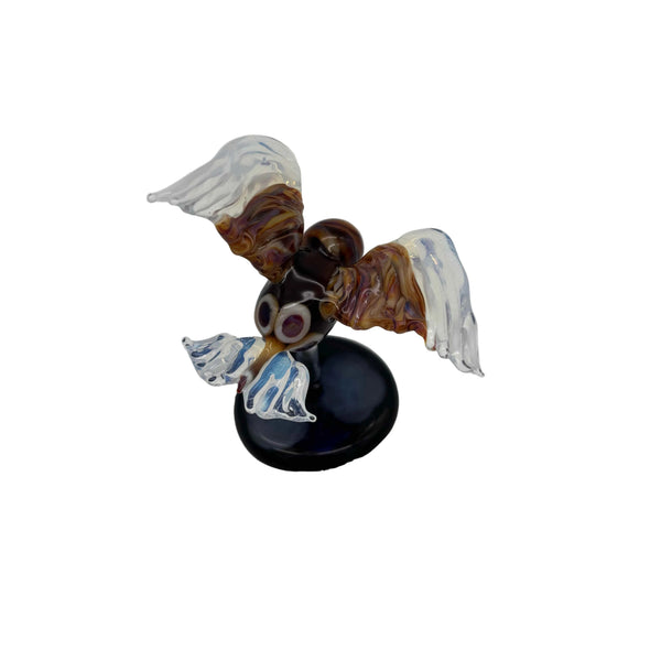 This is the Glass Soaring Hawk Sculpture by Biting Glass available at Ritual Colorado. A stylish borosilicate glass sculpture featuring a hawk soaring with wings out attached to a dark blue base with subtle "clouds".