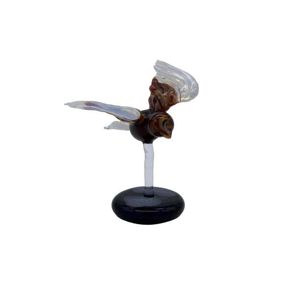 This is the Glass Soaring Hawk Sculpture by Biting Glass available at Ritual Colorado. A stylish borosilicate glass sculpture featuring a hawk soaring with wings out attached to a dark blue base with subtle "clouds".
