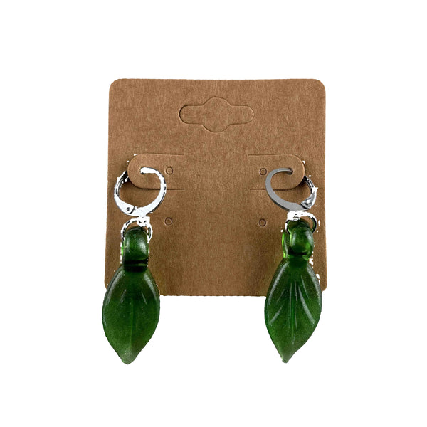 These are Sparkly Green Leaf Dangle Earrings by Biting Glass available at Ritual Colorado. Featuring vibrant glass leaves on leverback earring clasps these are a fun way to show off your love for local glass.