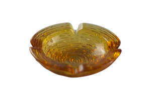 This is an Anchor Hocking Soreno Glass Ashtray in amber from Heady Vintage available at Ritual Colorado. It features a shallow well in the center with four indents around the edge for easy storage of your dry herb vaporization and dabbing tools. 