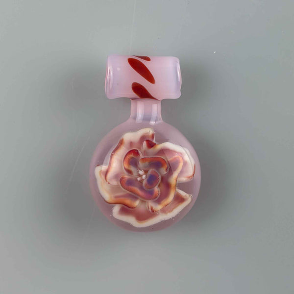 This is the Pink Rainbow Flower Medallion Pendant by Biting Glass available at Ritual Colorado. A beautiful handmade borosilicate jewelry piece with hidden sparkly details. 