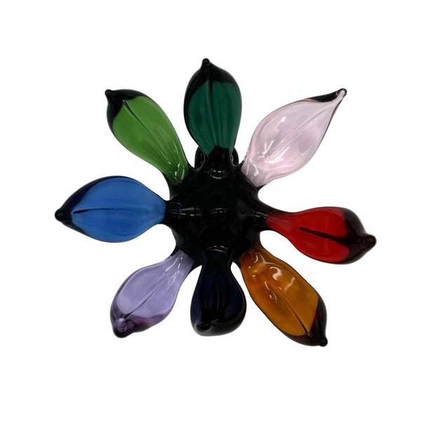 This is the Rainbow (Black Center) Glass Flower Wall Hanging by Biting Glass available at Ritual Colorado. Featuring vibrant glass colors this handcrafted decor piece is the perfect way to spruce up a wall and comes alive in front of a window or other light source.
