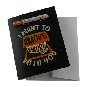 The "I Want To Smoke S'more Weed With You" Greeting Card by KushKards with matching metal One Hitter available at Ritual Colorado. A fun Colorado and cannabis-themed greeting card for the outdoorsy stoner in your life.