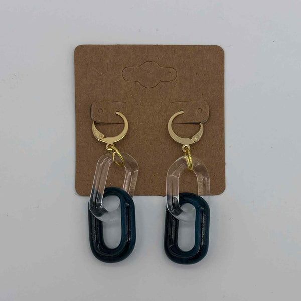 These are 2 link Sparkle Blue Glass Chain Earrings by Biting Glass available at Ritual Colorado. Featuring vibrant color accents these handmade jewelry pieces are the perfect accent accessory.