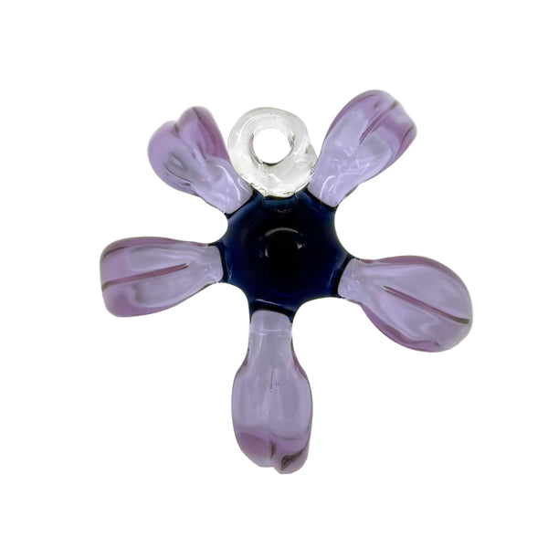 This is the Tropical Purple / Blue Glass Flower Wall Hanging by Biting Glass available at Ritual Colorado. Featuring vibrant glass colors this handcrafted decor piece is the perfect way to spruce up a wall and comes alive in front of a window or other light source.