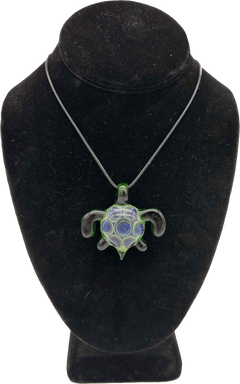 This is the Swimming Sea Turtle Pendant by Biting Glass available at Ritual Colorado. Handmade from borosilicate glass, this piece of wearable art features vibrant colors and subtle details.