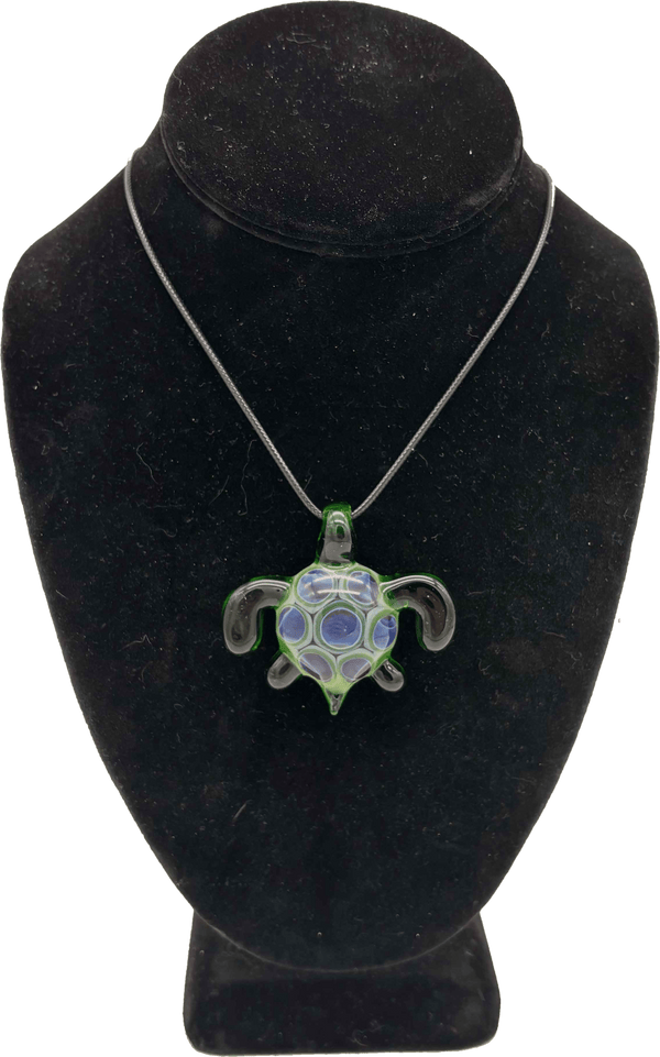 This is the Swimming Sea Turtle Pendant by Biting Glass available at Ritual Colorado. Handmade from borosilicate glass, this piece of wearable art features vibrant colors and subtle details.