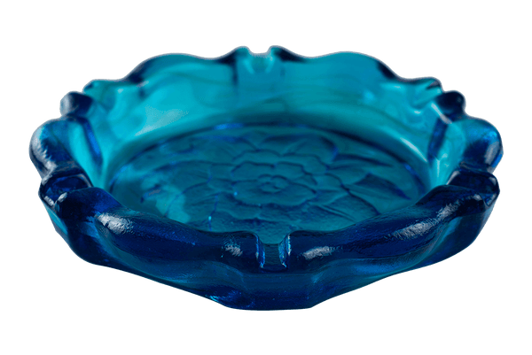 This is the Tiara Indiana Glass Horizon Blue Lotus Ashtray from Heady Vintage available at Ritual Colorado. The large blue ashtray features an imprinted flower in the base and many channels for keeping your joints, dry herb devices and accessories organized.