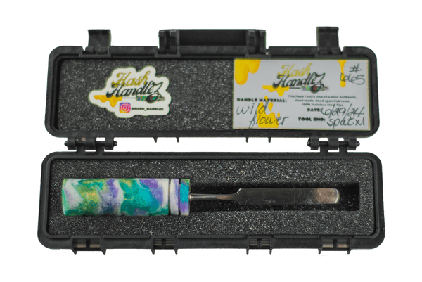 This is the Wild Flower dab tool from Hash Handlez available at Ritual Colorado. A beautiful handmade dabber that features a resin handle and hard protective case.