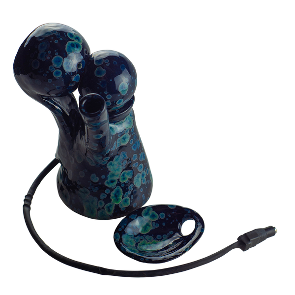 This is the VapBong Obsidian Old School Mini OAB from Jaxel's Art available at Ritual Colorado. It is an all-in-one ceramic water piece and dry herb vaporizer capable of powerful vapor and delicious flavors. Simply set the power level on the included voltage meter and after preheating load your material into the ceramic bowl, place under the heater and begin to inhale. 