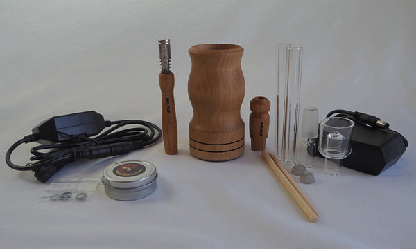 This is Ed's TnT WoodScents AromaLog shown in Cherry wood available at Ritual. The full kit is pictured including power cord and adapter, glass stems, glass water pipe adapter, glass aroma bowl, o-rings, Cherry stem and water pipe adapter, screens, and Ed's Bomb Ass Butter.