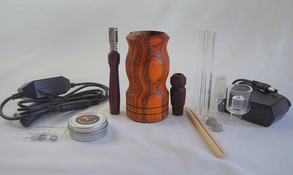 This is Ed's TnT Special Edition WoodScents AromaLog in Cocobolo wood available at Ritual. Shown with everything included (power cord and adapter, glass stems, glass water pipe adapter, glass aroma bowl, Ed's Bomb Ass Butter, O-Rings, WoodScents AromaLog, Cocobolo stems and water pipe adapter.